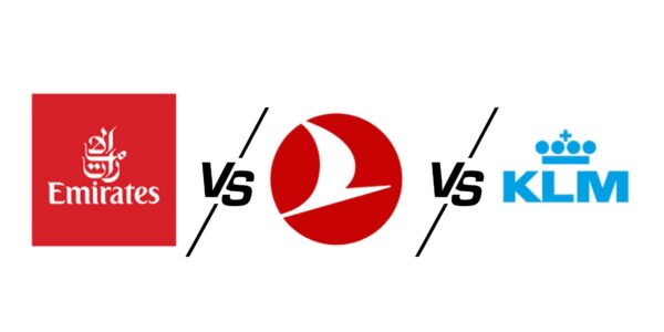 Side-by-side airline logo comparison of Emirates, Turkish Airlines, and KLM. The Emirates logo is on the left in red with Arabic script, the Turkish Airlines logo is in the center with a white bird in a red circle, and the KLM logo is on the right in blue with a crown symbol. 'VS' is written between each airline logo indicating a comparison.