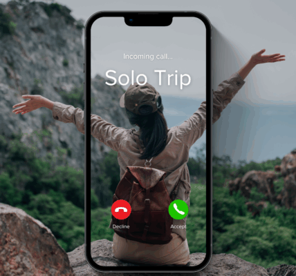 A woman sits on a rock facing a scenic mountain landscape with her arms raised joyfully. Overlaid on the image is a smartphone screen showing an incoming call from "Solo Trip," with options to decline or accept. She wears a green cap, long-sleeve shirt, and a brown backpack, symbolizing the excitement of solo travel and adventure.