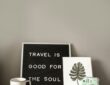 the boujee duck Letter board sign reading Travel Is Good For The Soul with passport and camera