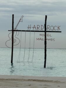 Hard Rock Hotel Maldives - the boujee duck the boujee duck Hard Rock Hotel Maldives sign standing in turquoise ocean water